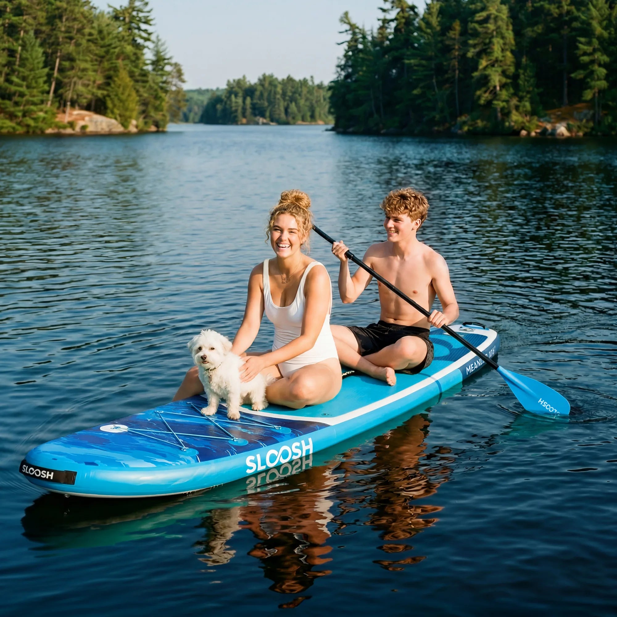 Couple with dog paddleboarding on a calm lake
